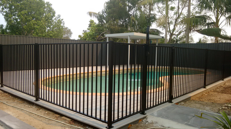 Custom powder coated aluminium pool fencing. 16mm square verticals, 45mm square posts. Refined fixings.