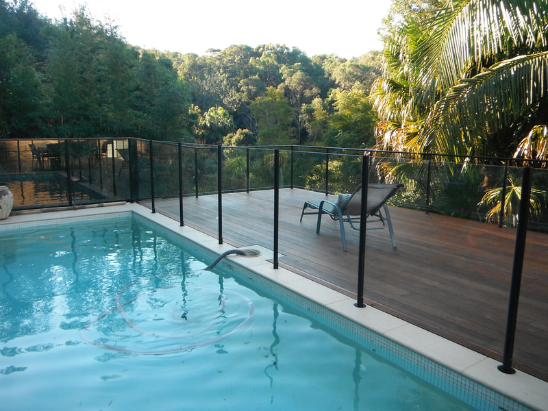 Semi frameless glass pool fencing. Glass fixed with powder coated slotted aluminium posts.